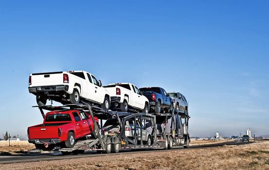 Semi-truck with car hauler or sometimes called a traveling parking lot.