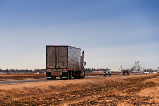 Early morning traffic on a rural American highway as people start going to work on a winter day.