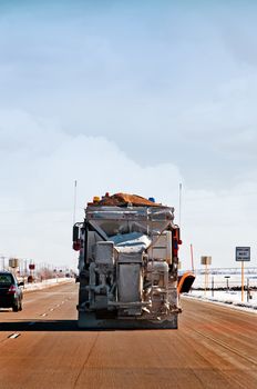 Snowplow near Lamar, Colorado, USA on US highway 50 in December.