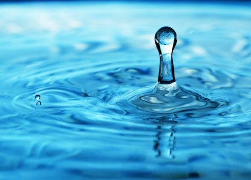 Stop action photo of a deep blue water drop