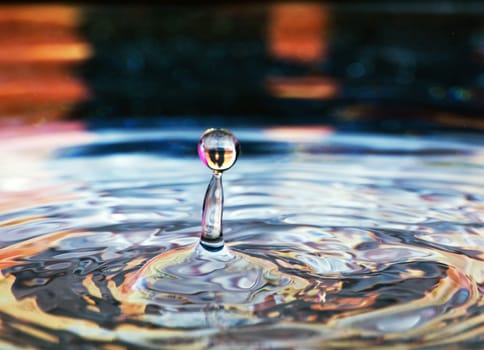 Water drop with a muti-colored reflection in it