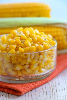 Yellow steamed corn with salt and peper in a bowl