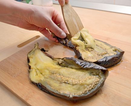 Unskin roasted eggplants for salad