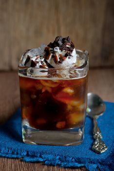 Iced coffee with ice cream on wooden table