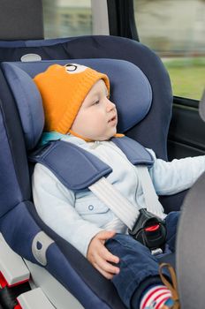 Cute boy sitting in the car seat 