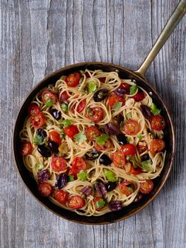 close up of rustic italian spaghetti puttanesca pasta