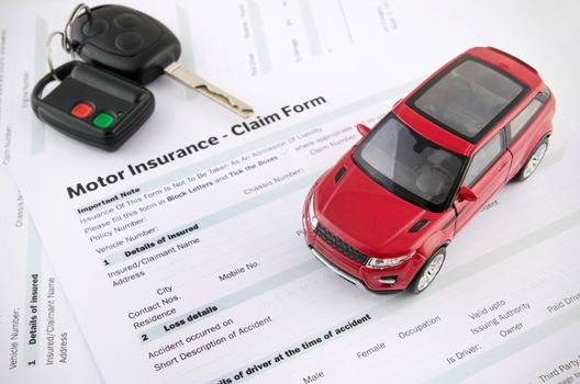 Car toy and keys on insurance documents . Protection car concept