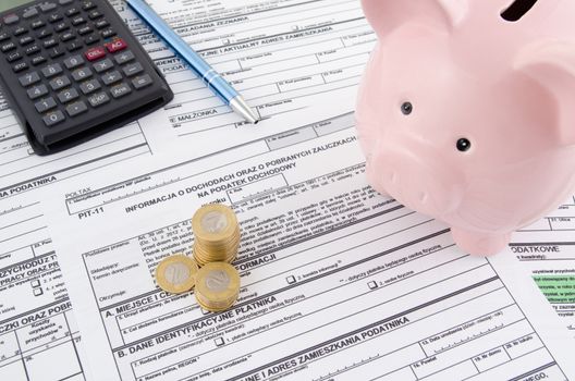 Polish income tax forms with calculator and piggybank