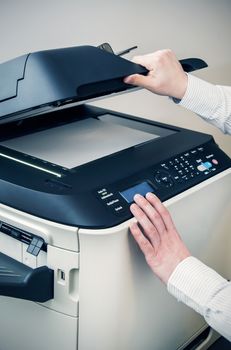 Man using scanner multifunction device in office