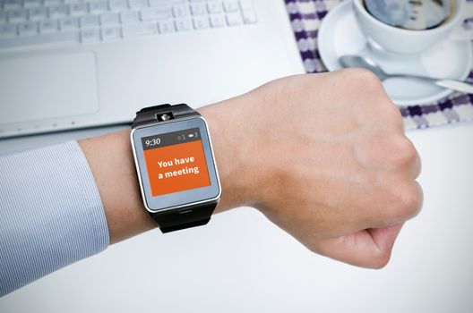 Businessman working with smart watch in restaurant. Notification on screen