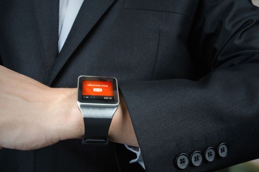 Close up of businessman receives message notification on smart watch