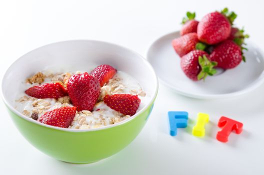 Close up of homemade fruit plate with yogurt, strawberries, on white background