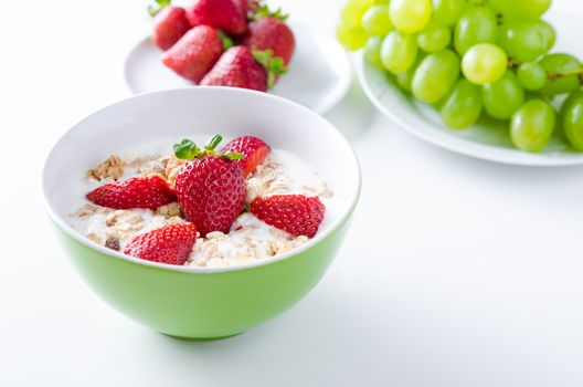 Close up of homemade fruit plate with yogurt, strawberries and granola