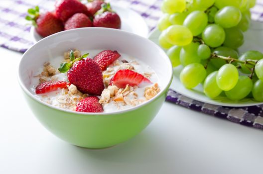 Close up of homemade fruit plate with yogurt, strawberries and granola