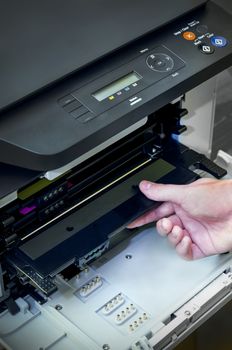 Close up of man puts toner in the printer