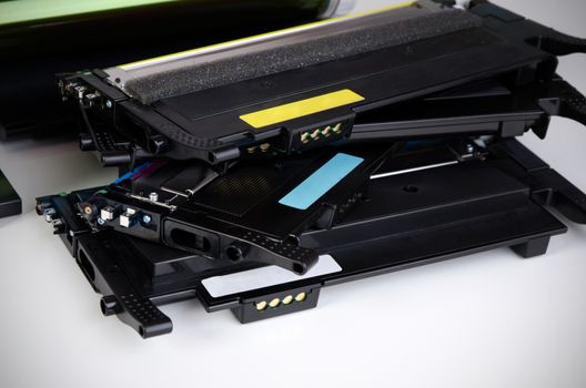 Toner cartridge set for laser printer. Computer supplies on white background.