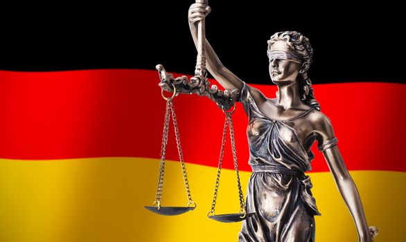 Themis with scale, symbol of justice on German flag background composition