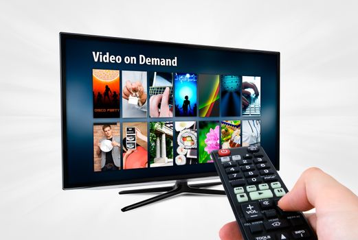 Video on demand VOD service on smart TV. Remote control in hand.