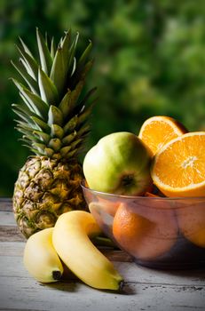 Lot of fresh fruits on wooden background. Photo on nature