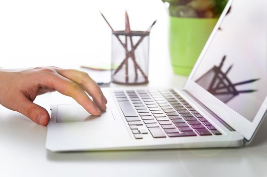 Man working with modern laptop in office. Hands typing on keyboard