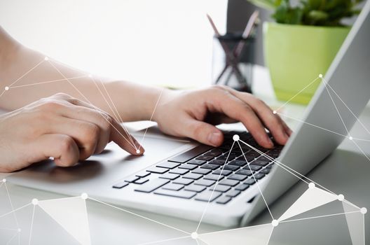 Man working with modern laptop in office. Hands typing on keyboard