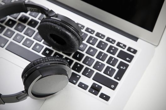 Close up of audio headset on laptop. Wireless headphones