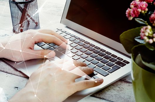 Man working with modern laptop in office. Hands typing on keyboard