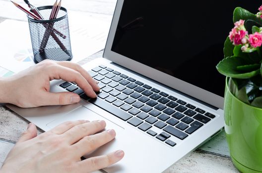 Man working with modern laptop in office. Hands typing on keyboard