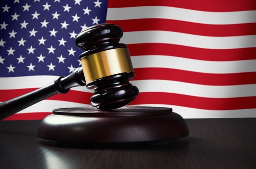 Wooden gavel with USA flag in background. Justice and law symbol