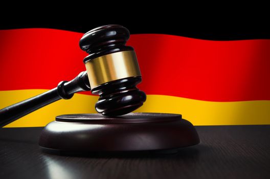 Wooden gavel with German flag in background. Justice and law symbol