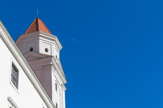 Detail view on one of the towers of castle in Bratislava, Slovakia, which is part of UNESCO World Heritage Site. Bright blue summer sky.