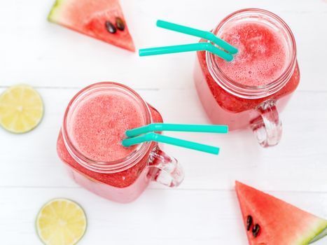 Watermelon smothie and slices on white wooden background. Top view