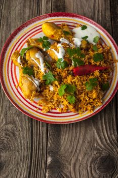 Chicken curry on the colorful plate on the wooden table