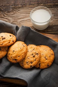 Chocolate chip cookies  with milk on the wooden table vertical
