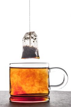 Brewed tea with tea bag vertical