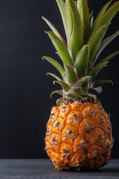 Pineapple on the black table vertical