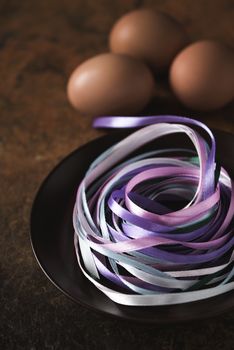 Blue ribbons in the plate with blurred eggs