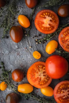 Tomatoes mix  with herbs on the stone table vertical