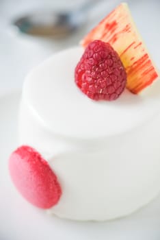 White cake with raspberry vertical