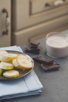Milk with banana and chocolate slices