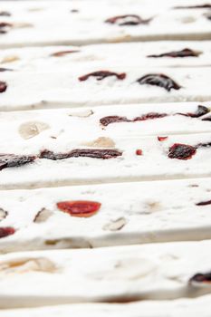 Nougat with fruit and nuts background vertical