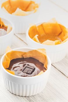 Chocolate mass for fondant in the ramekin vertical