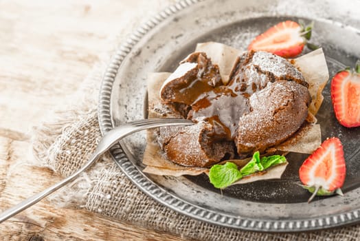 Chocolate fondant on the old metal plate horizontal