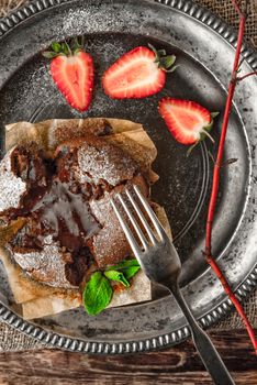 Chocolate fondant on the old metal plate vertical