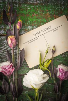 Postcard with eustoma  on the wooden table vertical
