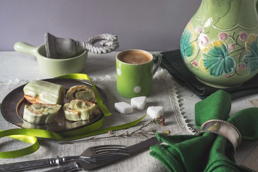 Eclair with green decorations on the table horizontal
