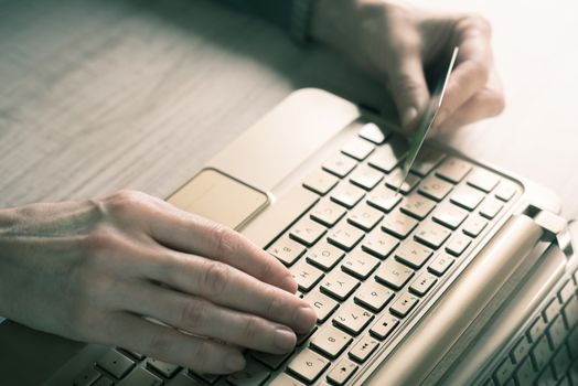 Hands with credit card and notebook