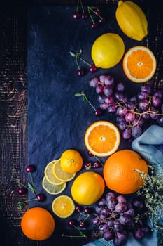 Different fruit on the dark background vertical
