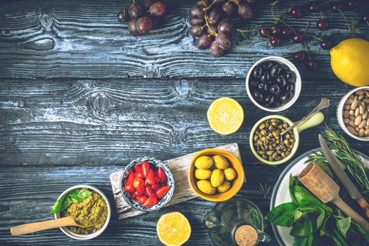 Concept of Mediterranean cuisine. Different fruit , herbs and appetizers on the blue wooden table