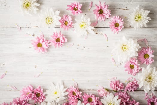 Pink and white flowers on the white wooden table
